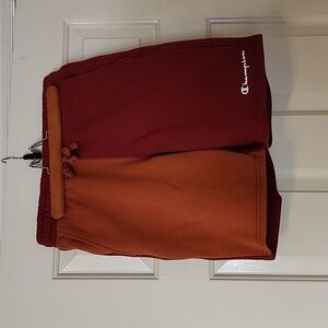 Champion size XS men's sweat shorts dark red with orange.